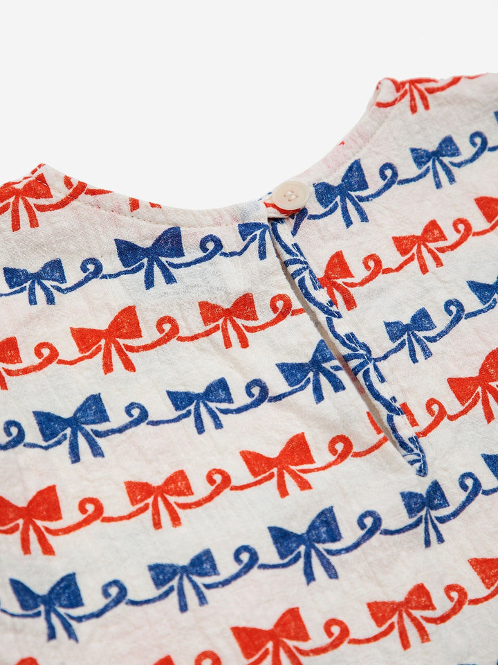 リボンボウを全面にあしらった織りブラウス